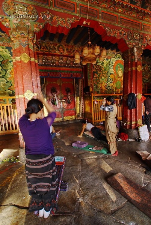 Tibet, Lhasa, pilgrims praying in frond of Jokhang temple